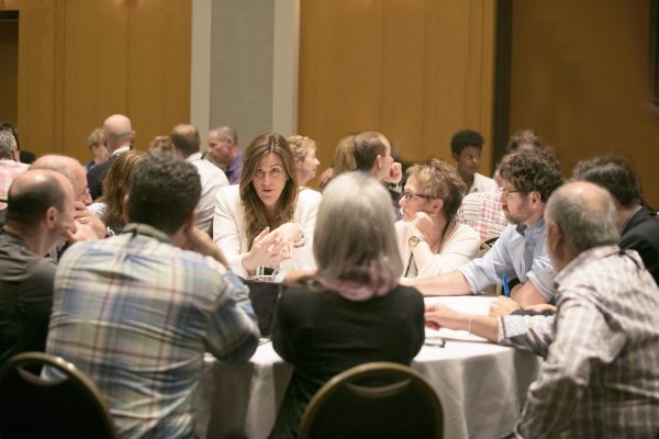 Group of people around a table having a discussion